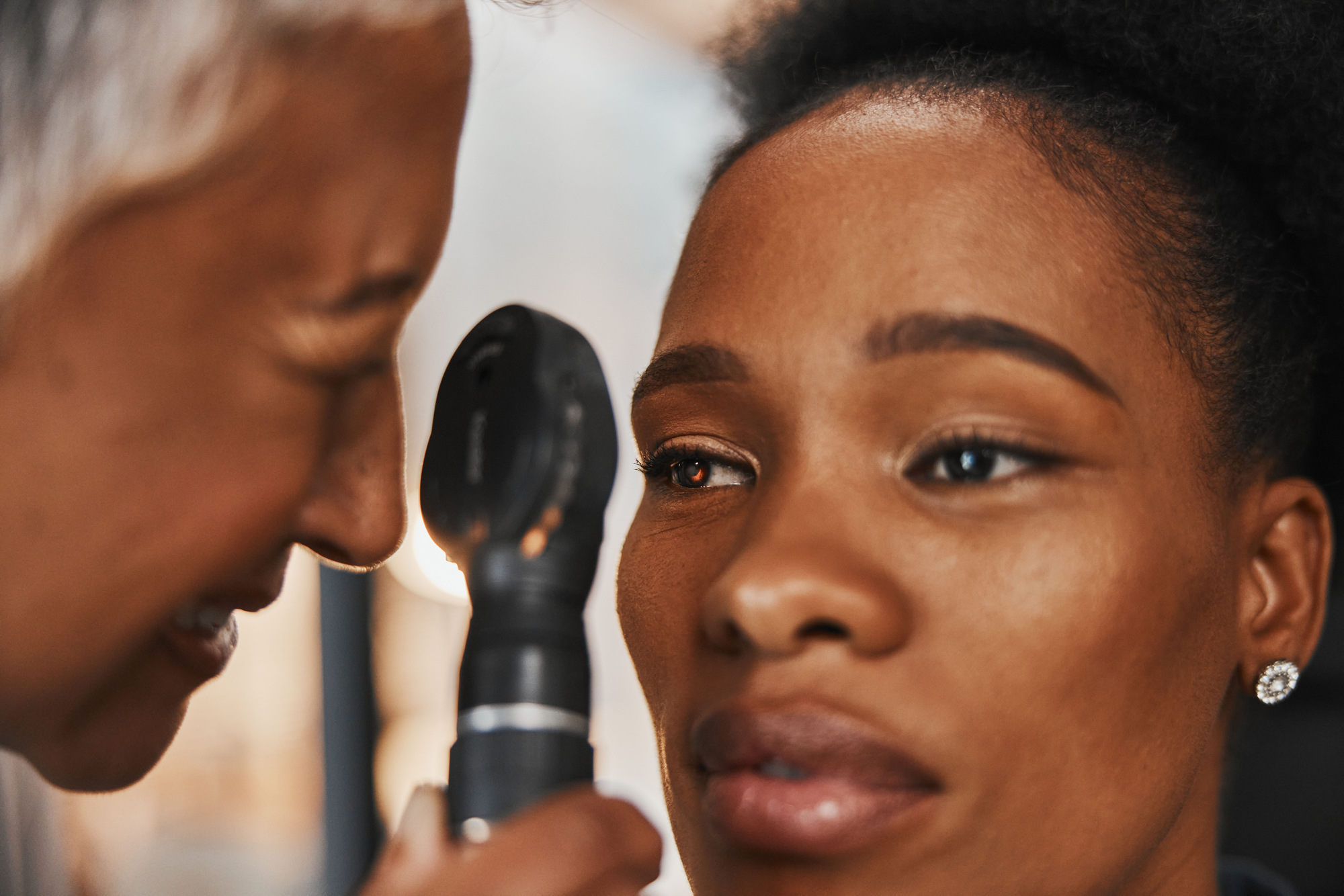 Doctor, face or black woman in eye exam assessment consultation for eyesight at optometrist office