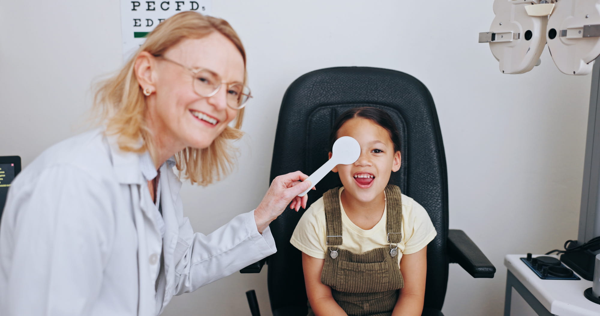 Doctor, occluder or kid in eye test at optometry clinic for eyewear, health or sight wellness. Tool.