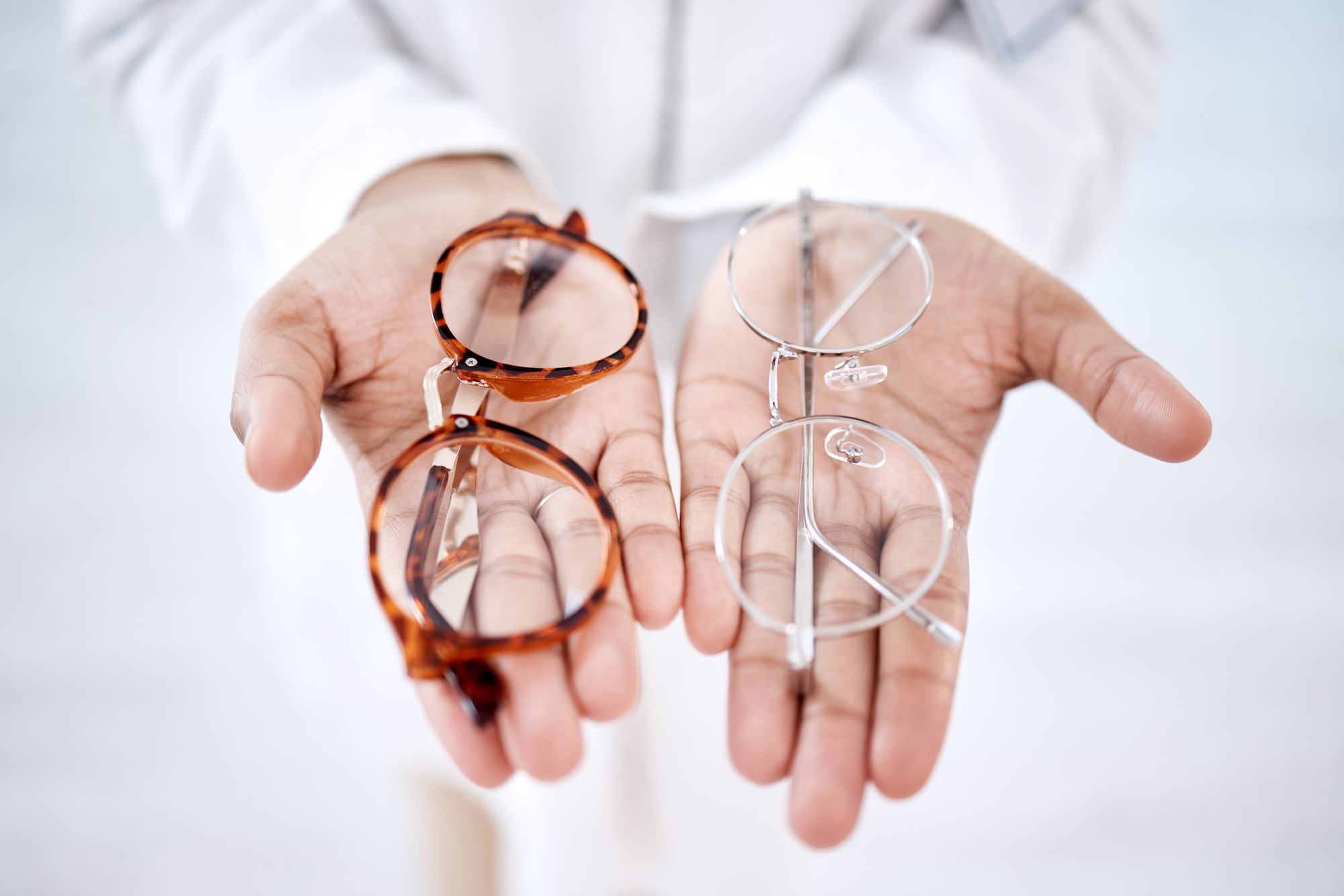Optometry, vision and hands with glasses for choice, option and choosing medical product for eyes. .