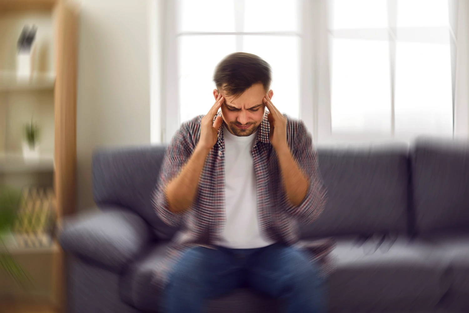 A man experiencing visual vertigo due to eye strain