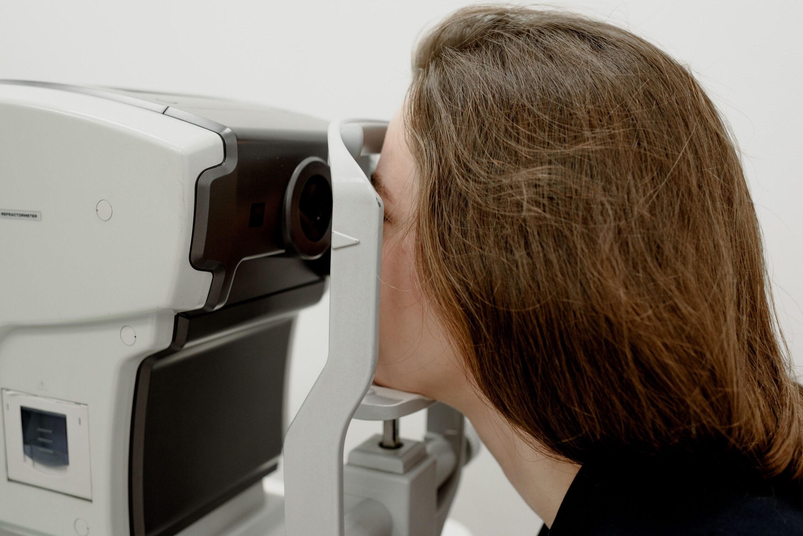 Patient undergoing computerized eye testing during an oscillopsia and visual stability evaluation