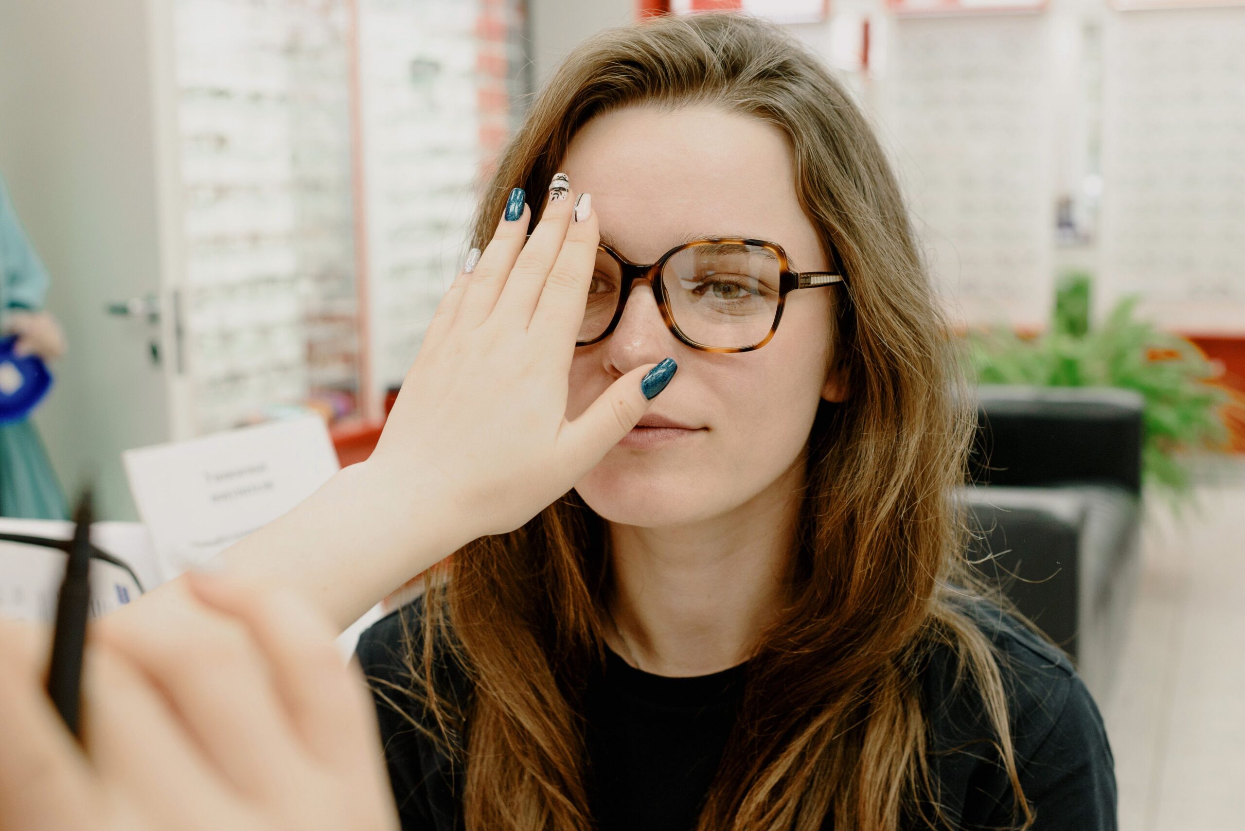 Patient undergoing binocular vision testing during an evaluation for visual instability and oscillopsia symptoms