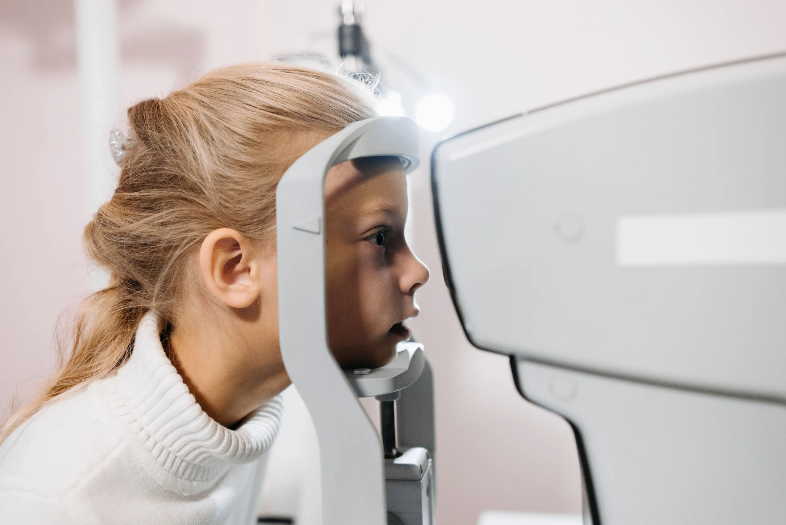 Child undergoing an eye exam to diagnose astigmatism and vision problems in kids