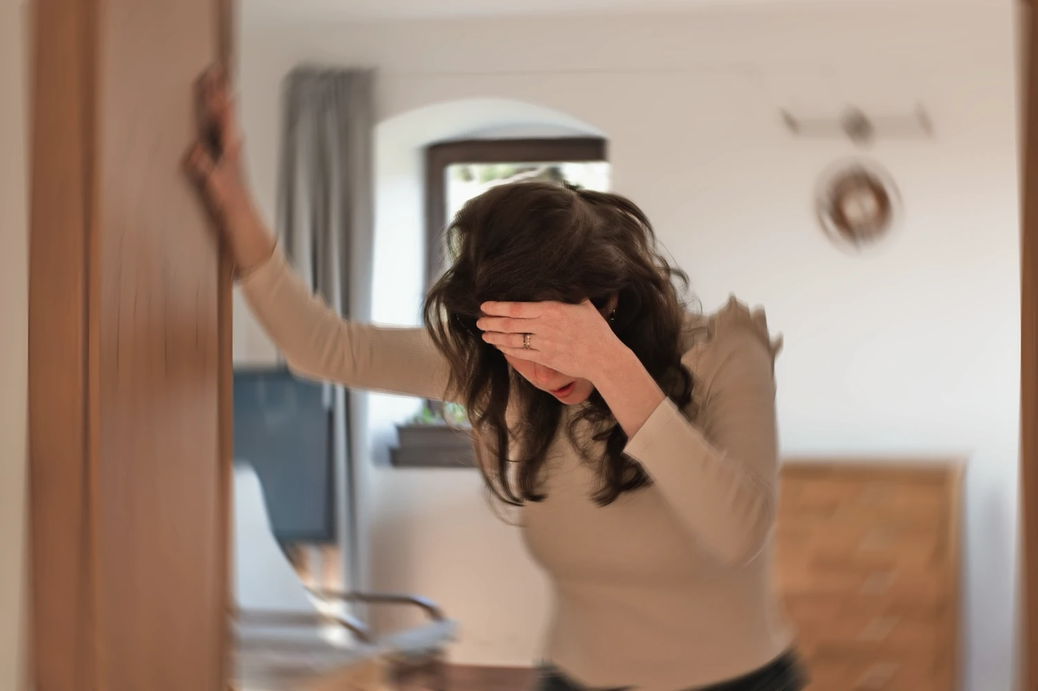 Blurred photo of a woman suffering from vertigo